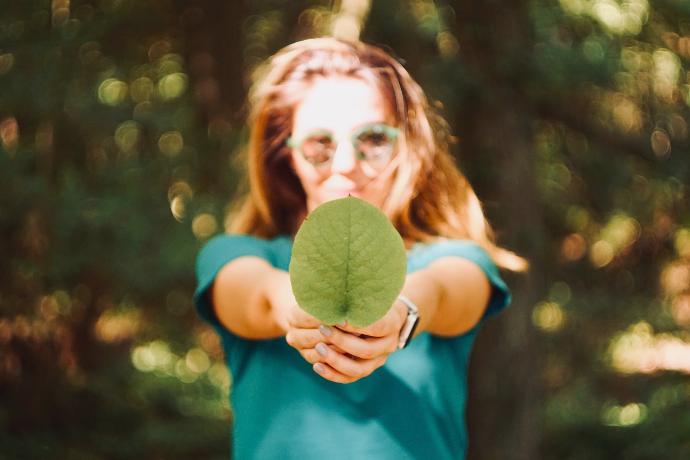 woman holding leaf